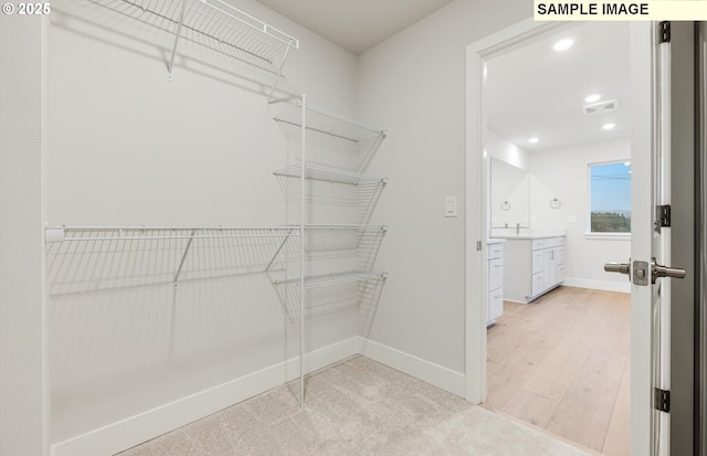 spacious closet with light wood-type flooring