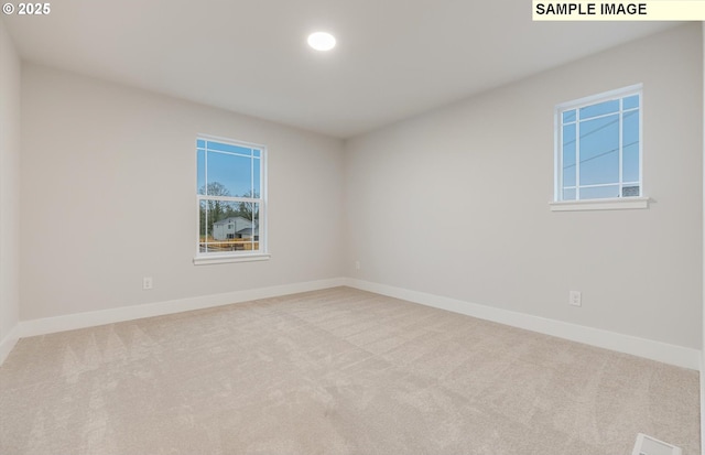 empty room with carpet flooring, baseboards, and recessed lighting