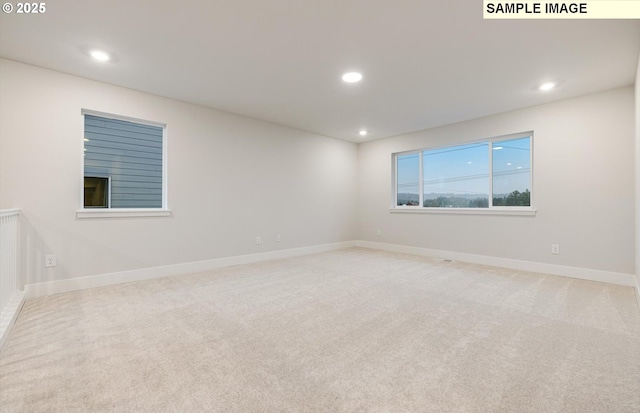 carpeted empty room with recessed lighting and baseboards
