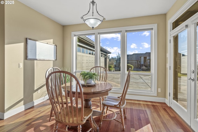 dining space with hardwood / wood-style floors