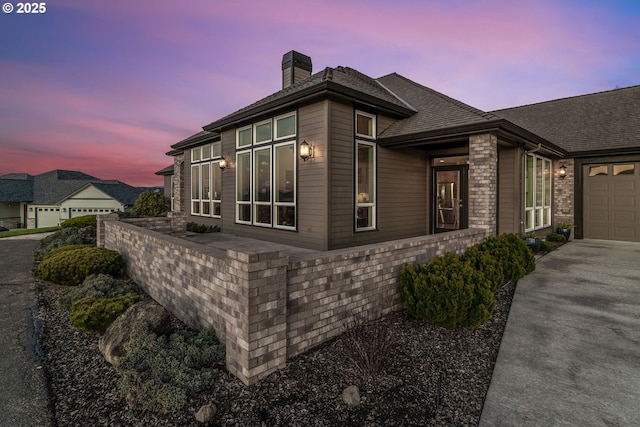 property exterior at dusk with a garage