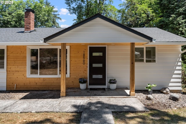 18560 Lower Midhill Dr, West Linn, OR 97068 - view of front of home with a shingled roof and a chimney