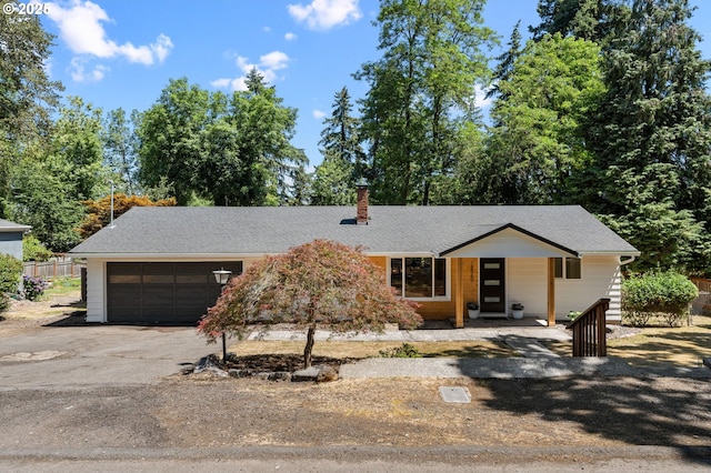 18560 Lower Midhill Dr, West Linn, OR 97068 - mid-century modern home featuring driveway, an attached garage, a chimney, and a porch