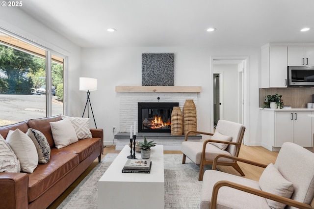 18560 Lower Midhill Dr, West Linn, OR 97068 - living room with recessed lighting, light wood-type flooring, and a glass covered fireplace