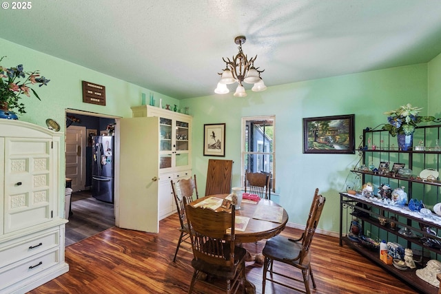 51014 Dement Creek Rd, Myrtle Point, OR 97458 - dining room featuring a chandelier, dark wood-type flooring, and a textured ceiling