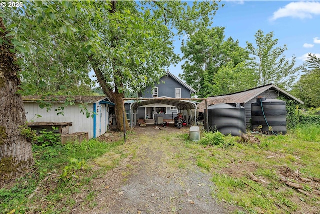 51014 Dement Creek Rd, Myrtle Point, OR 97458 - view of yard with a detached carport, dirt driveway, and central AC