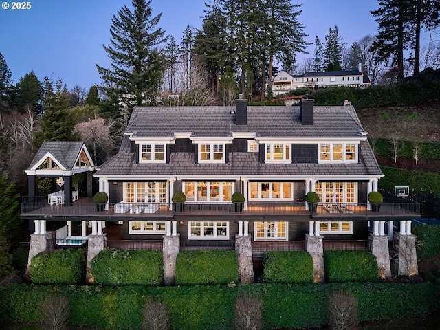 rear view of house featuring french doors and a balcony