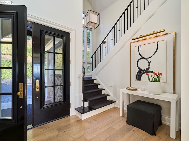 entrance foyer featuring light hardwood / wood-style floors and a high ceiling