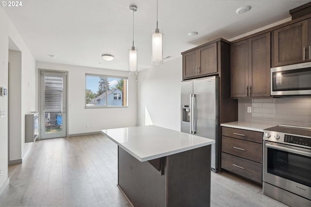 kitchen featuring decorative light fixtures, dark brown cabinets, backsplash, and stainless steel appliances