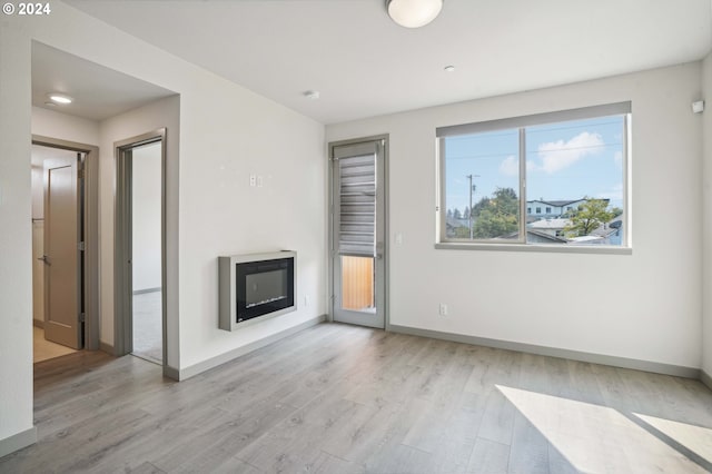 unfurnished living room with light wood-type flooring