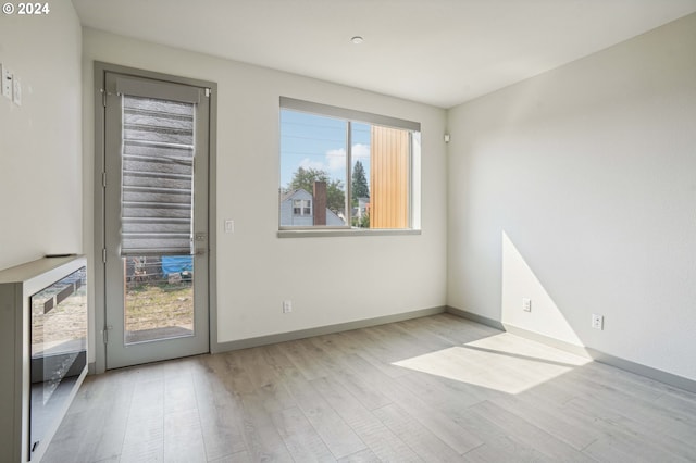 unfurnished room with light hardwood / wood-style flooring