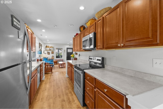 4604 SE 30th Ave, Portland, OR 97202 - kitchen with appliances with stainless steel finishes, light countertops, brown cabinets, light wood-style flooring, and recessed lighting