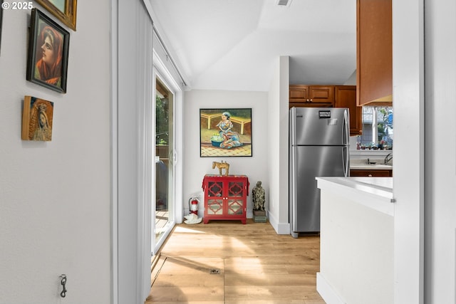 4604 SE 30th Ave, Portland, OR 97202 - hallway featuring light wood-style floors, a sink, baseboards, and vaulted ceiling
