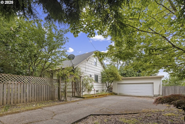 view of side of property with a garage and fence