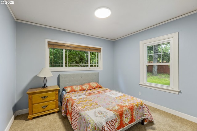 carpeted bedroom with multiple windows, crown molding, and baseboards