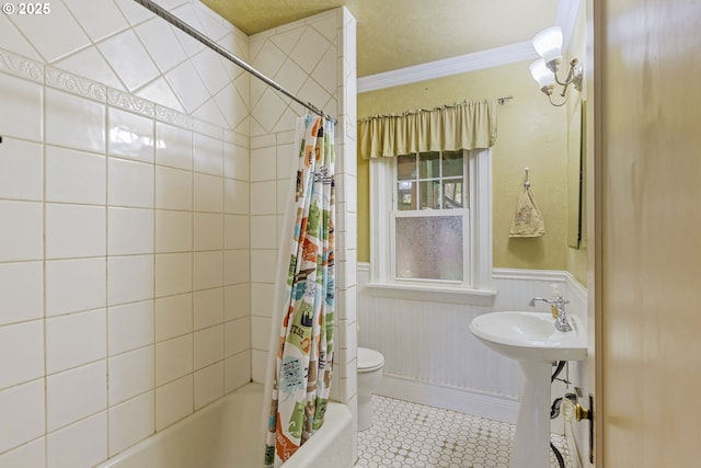 full bath with shower / bath combination with curtain, toilet, a wainscoted wall, ornamental molding, and a sink