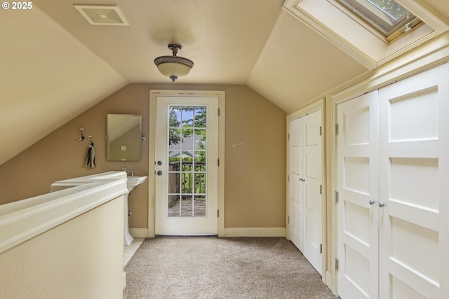 bonus room featuring a skylight, light carpet, lofted ceiling, and baseboards
