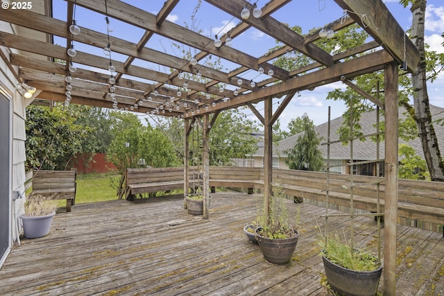 wooden terrace featuring fence and a pergola