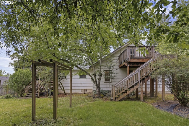 rear view of house featuring stairway and a deck