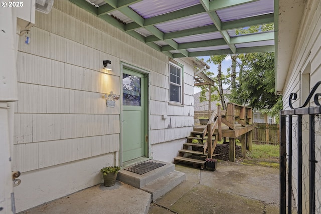 property entrance featuring fence and a patio area