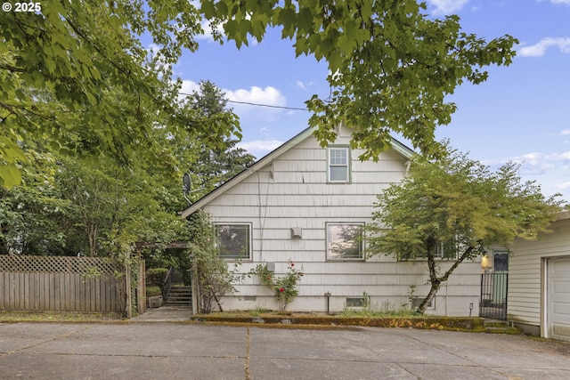 view of side of home with fence