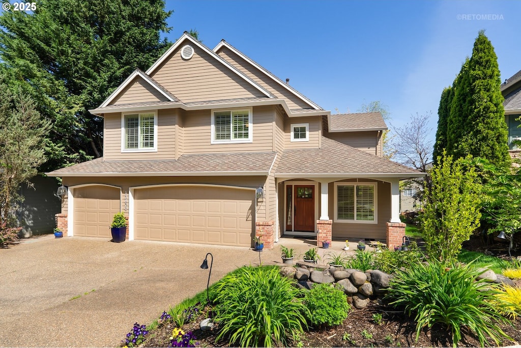 13829 SE Alta Vista Dr, Happy Valley, OR 97086 - view of front of property featuring a garage, driveway, a shingled roof, and covered porch
