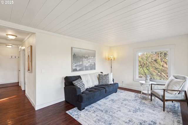 living room with ornamental molding, dark hardwood / wood-style floors, and wood ceiling