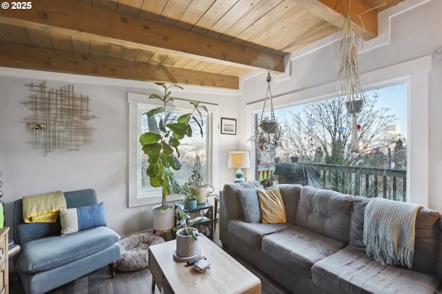 living room with wood ceiling, plenty of natural light, and beamed ceiling