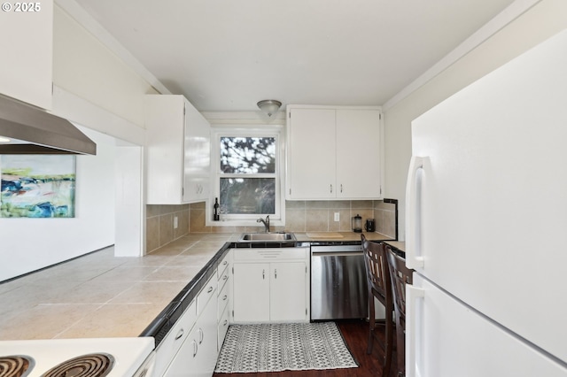 kitchen featuring white cabinetry, white appliances, and tasteful backsplash