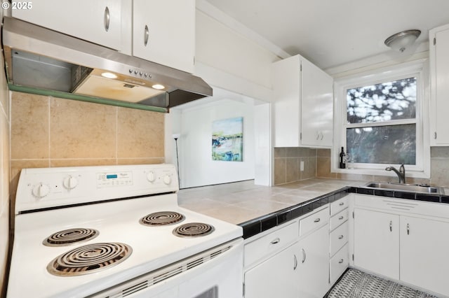 kitchen featuring tile countertops, sink, white cabinets, backsplash, and electric stove