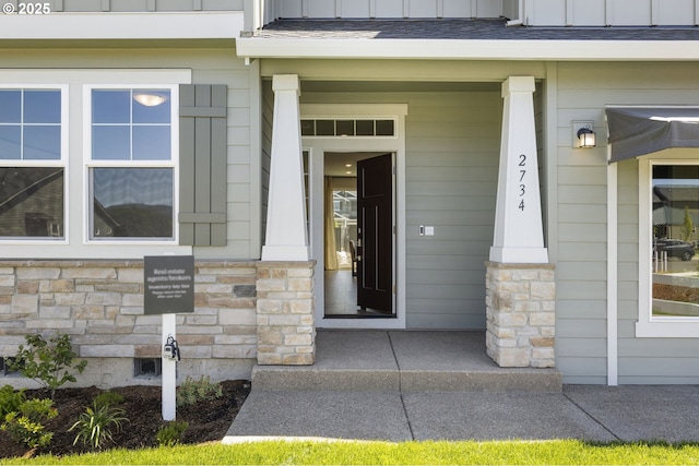 5603 Edward Ct SE, Albany, OR 97322 - view of exterior entry with a porch, stone siding, and board and batten siding