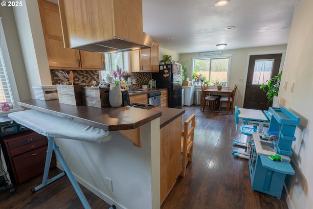 1727 E Washington Ave, Cottage Grove, OR 97424 - kitchen with freestanding refrigerator, stainless steel dishwasher, dark wood finished floors, backsplash, and a peninsula