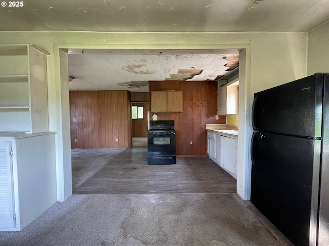 91456 State Rd, Coquille, OR 97423 - kitchen featuring black appliances, wooden walls, wood finished floors, carpet flooring, and light countertops