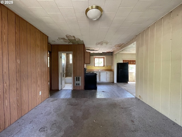 91456 State Rd, Coquille, OR 97423 - unfurnished living room featuring wooden walls, carpet floors, and heating unit