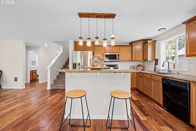 1225 3rd Ave, Hammond, OR 97121 - kitchen with stainless steel appliances, a sink, a kitchen breakfast bar, and dark wood-style floors