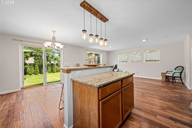 1225 3rd Ave, Hammond, OR 97121 - kitchen with hardwood / wood-style flooring, a chandelier, a breakfast bar, healthy amount of natural light, and recessed lighting