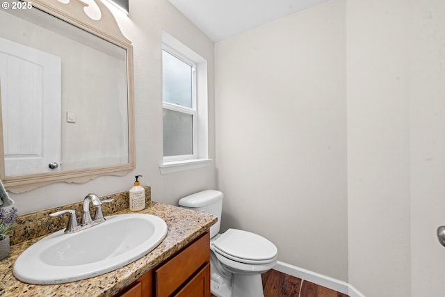 1225 3rd Ave, Hammond, OR 97121 - half bath with vanity, wood finished floors, toilet, and baseboards