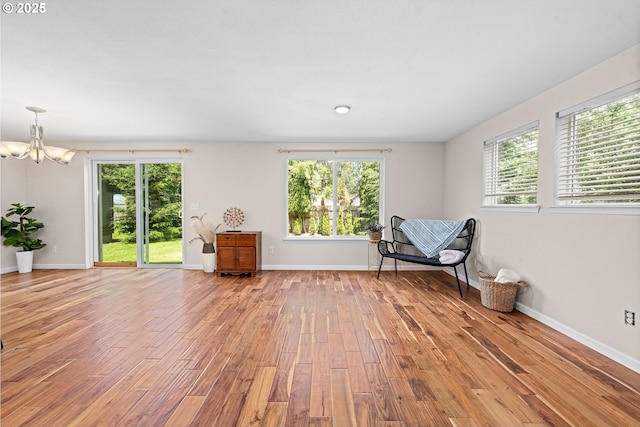1225 3rd Ave, Hammond, OR 97121 - sitting room featuring a chandelier, light wood-style floors, and baseboards
