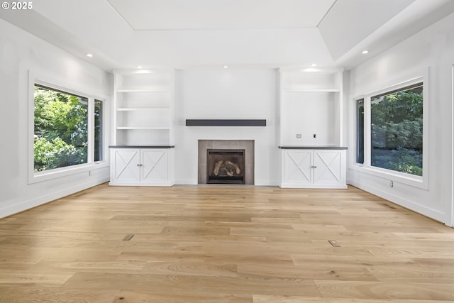 12643 S Iron Mountain Blvd, Portland, OR 97219 - unfurnished living room with healthy amount of natural light, a tiled fireplace, light wood-style floors, and recessed lighting