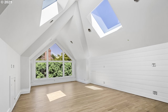 12643 S Iron Mountain Blvd, Portland, OR 97219 - bonus room featuring a skylight, wood finished floors, vaulted ceiling, and baseboards