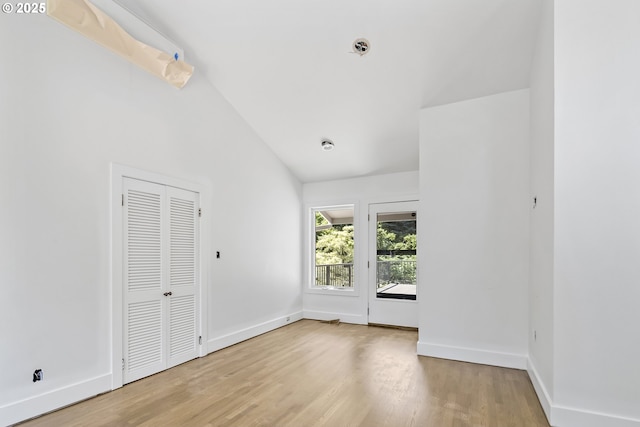 12643 S Iron Mountain Blvd, Portland, OR 97219 - spare room with lofted ceiling, wood finished floors, baseboards, and fire sprinkler in ceiling