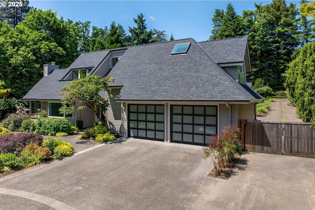 12643 S Iron Mountain Blvd, Portland, OR 97219 - view of front of house with an attached garage, roof with shingles, driveway, and a chimney