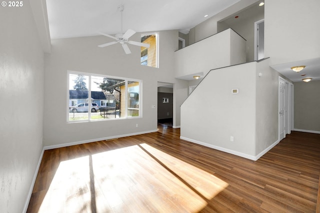 unfurnished living room with high vaulted ceiling, hardwood / wood-style floors, and ceiling fan