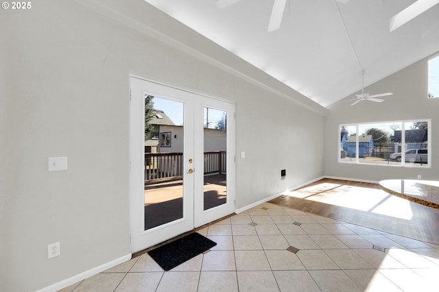 tiled spare room featuring high vaulted ceiling, a healthy amount of sunlight, ceiling fan, and french doors