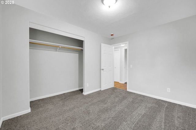 unfurnished bedroom featuring carpet flooring and a closet