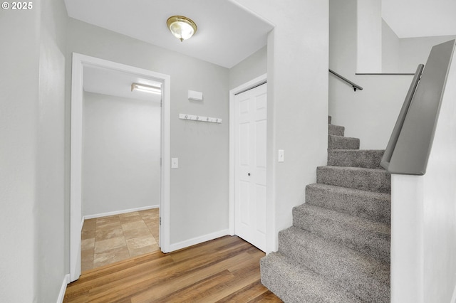 stairway with hardwood / wood-style floors