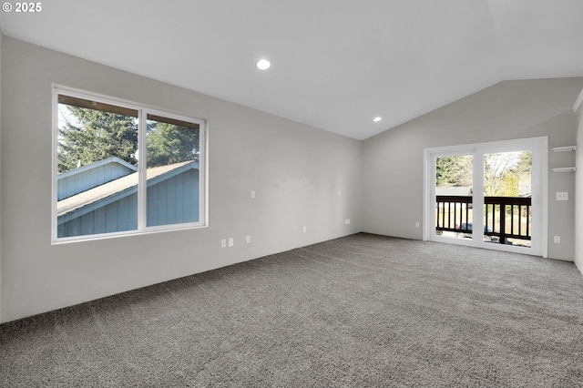 empty room featuring carpet floors and vaulted ceiling