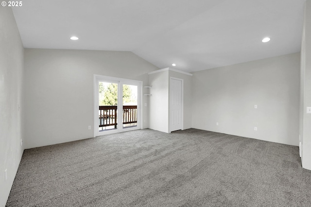 unfurnished living room featuring lofted ceiling and carpet flooring