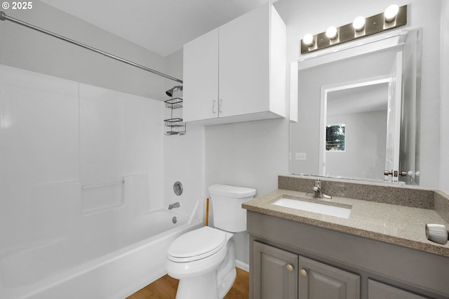 full bathroom featuring vanity, hardwood / wood-style floors, shower / bathtub combination, and toilet