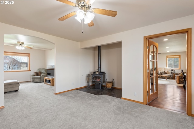 carpeted living area featuring a healthy amount of sunlight, ceiling fan, baseboards, and recessed lighting